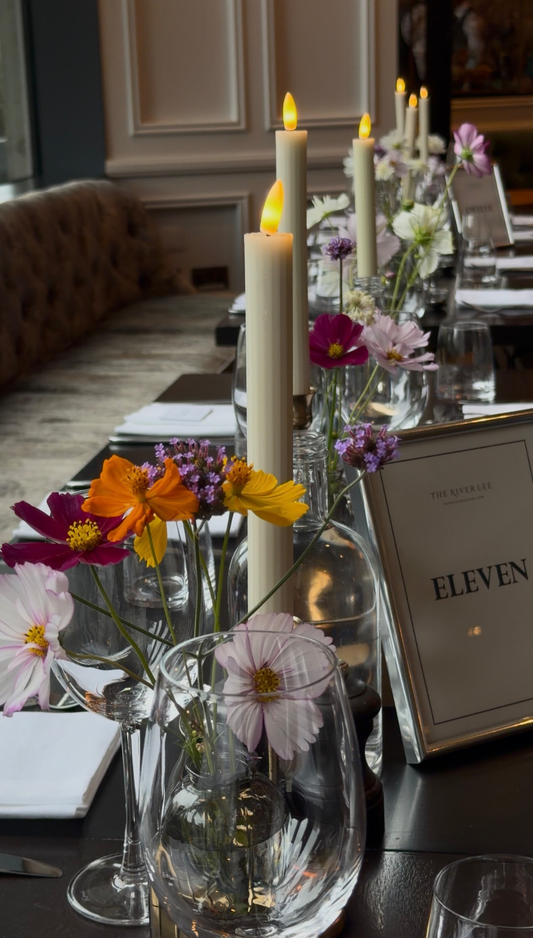 Candles and wildflower vases on a reception table at The River Lee