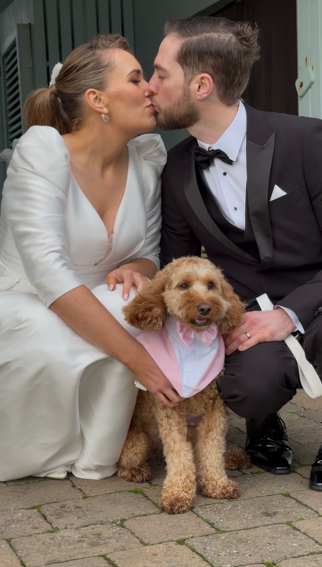 Siobhan and Podge with their dog in a pink bow tie