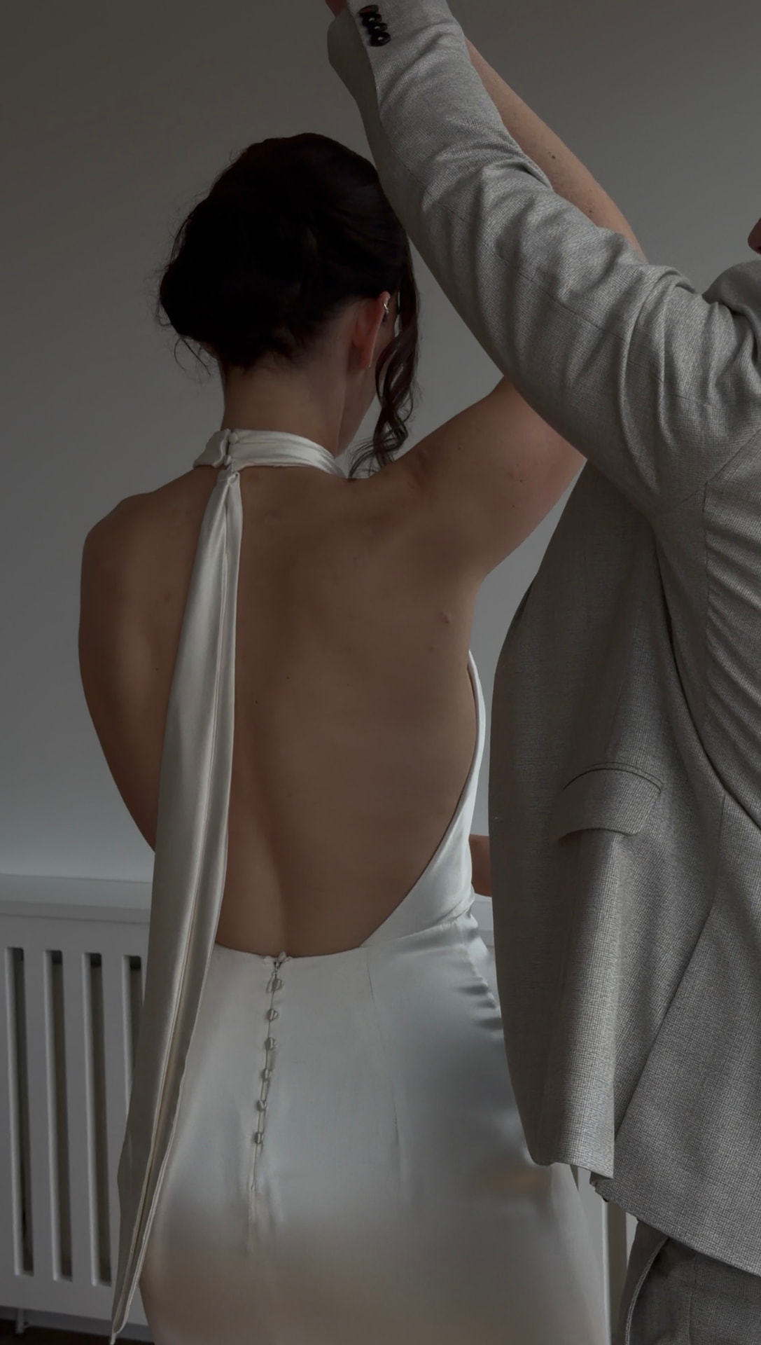 Orla and Steve dancing, showing the open back of her wedding dress