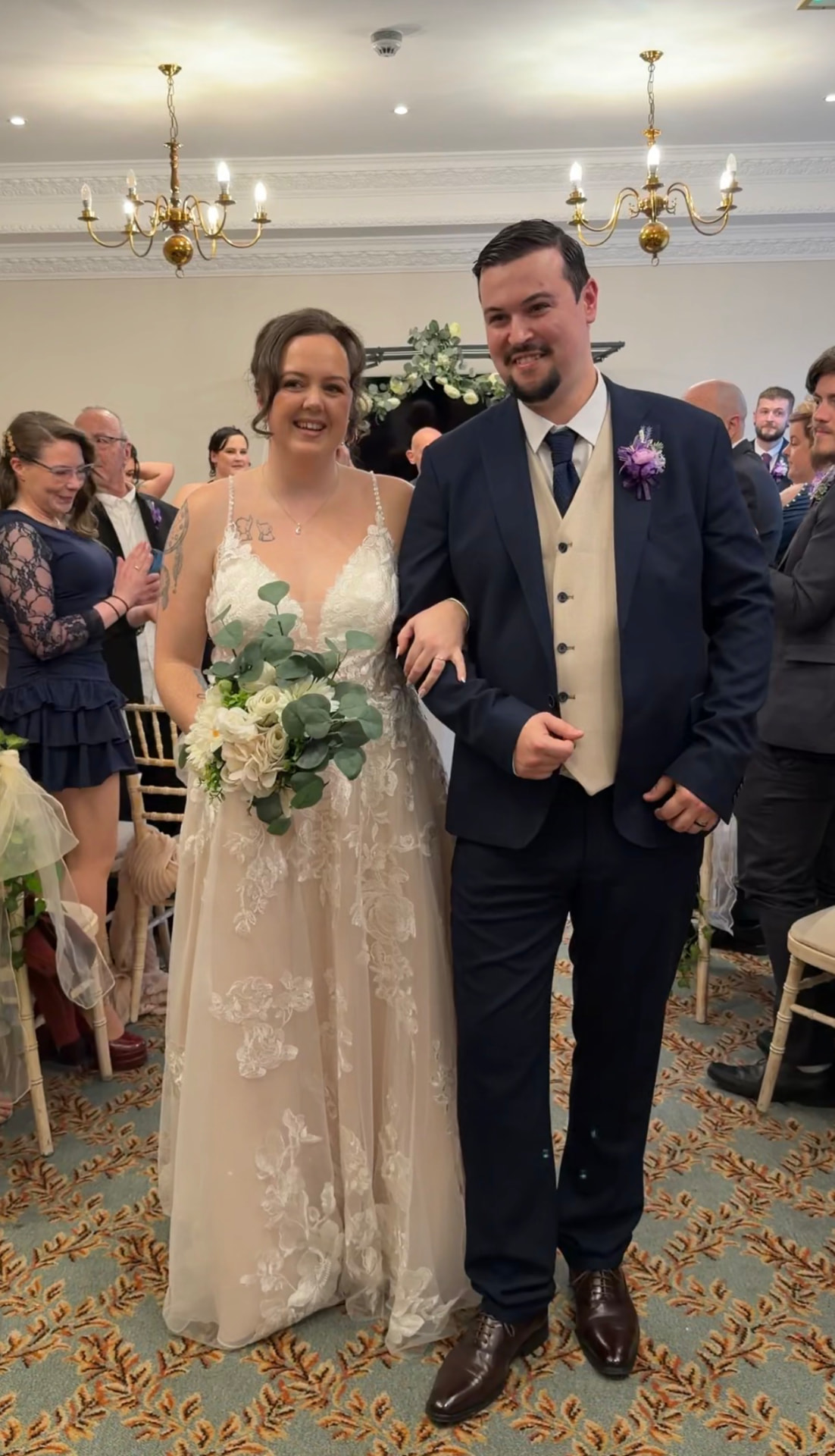 Lynda and Marcus walking back down the aisle as newlyweds