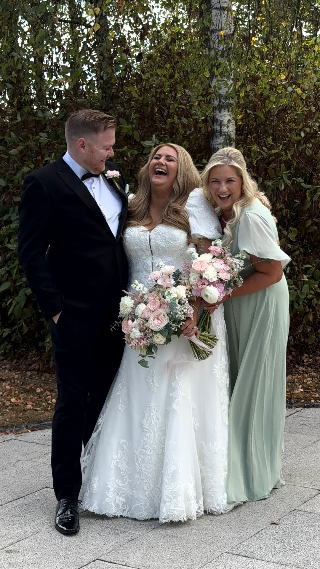 Sarah laughing with Thomas and her bridesmaid outside Druids Glen
