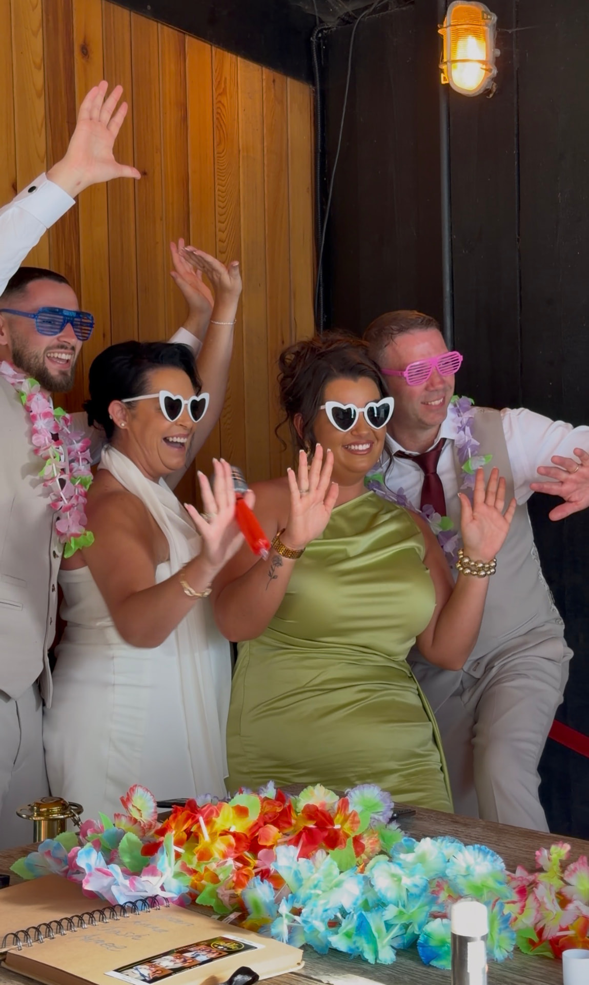 Yvonne, Trevor and their guests dancing with heart sunglasses at the reception